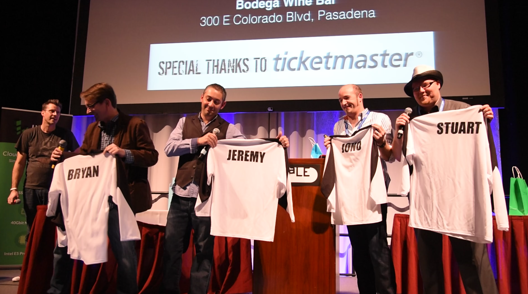 The four Bad Voltage presenters, being presented with branded SCaLE jerseys with names on the back