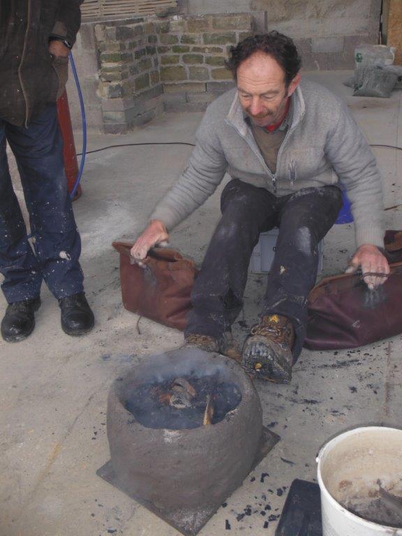 DorsetArtClass's tweet photo. Mark busily using the bellows under the Dutch barn - Discover the Ancient Techniques of Bronze Casting. https://t.co/RIOmjwccIE