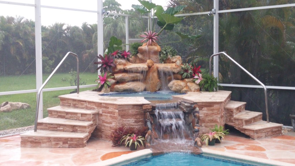OutdoorsAmazing's tweet photo. #Spa remodel with double #customwaterfall #stonepanels #travertine #custombackyard #amazingoutdoorsmiami #customspa https://t.co/T8Fy3cQtIN