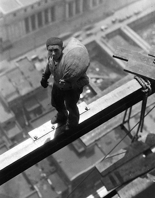 A worker on beam of building at 40 Wall Street, 1930