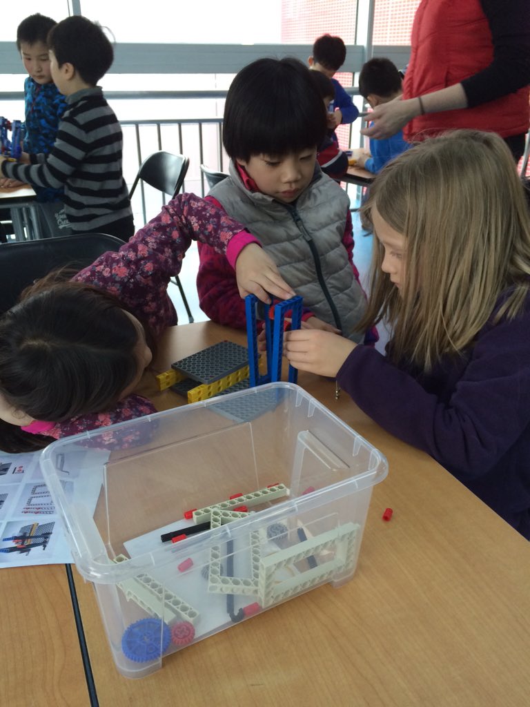 Grade 2 students collaborating to build mechanical hammers #learnisb