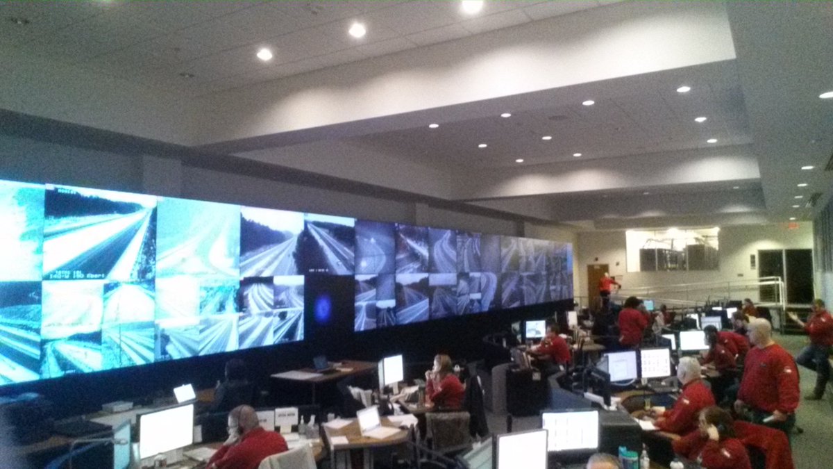 NCDOT's tweet photo. The Statewide Transportation Operations Center (STOC). 75 monitors of live feeds from ~460 traffic cameras in NC. https://t.co/Fv4S0Yj1Dk