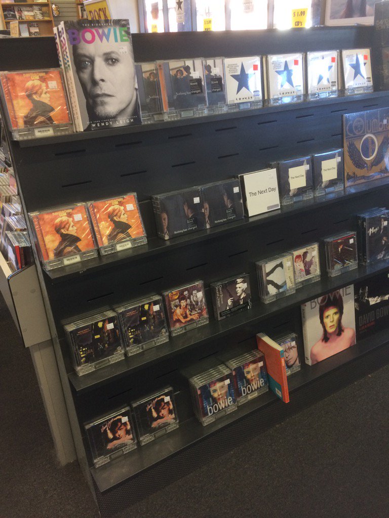 DavidAllen909's tweet photo. David Bowie back in stock at @rhinoclaremont, still on first endcap, as Bowie concert video plays. https://t.co/n5stM84vdU