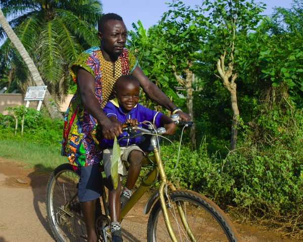KentPage's tweet image. Emmanuel takes his son, Isaac 8, to school in Elmina in #Ghana's Central Region. #unicef #education v/@unicefghana