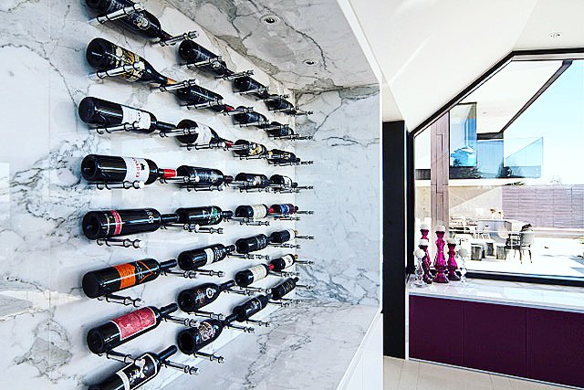 This beautiful combination of precious alloys and Carrara-marble makes for an impressive contemporary wine display. #winerack #winecellar