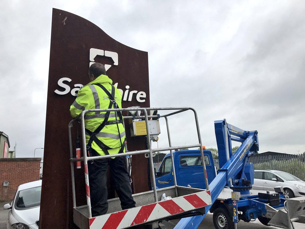 Practice what you preach - JD giving our Totem Sign a clean! #Signage