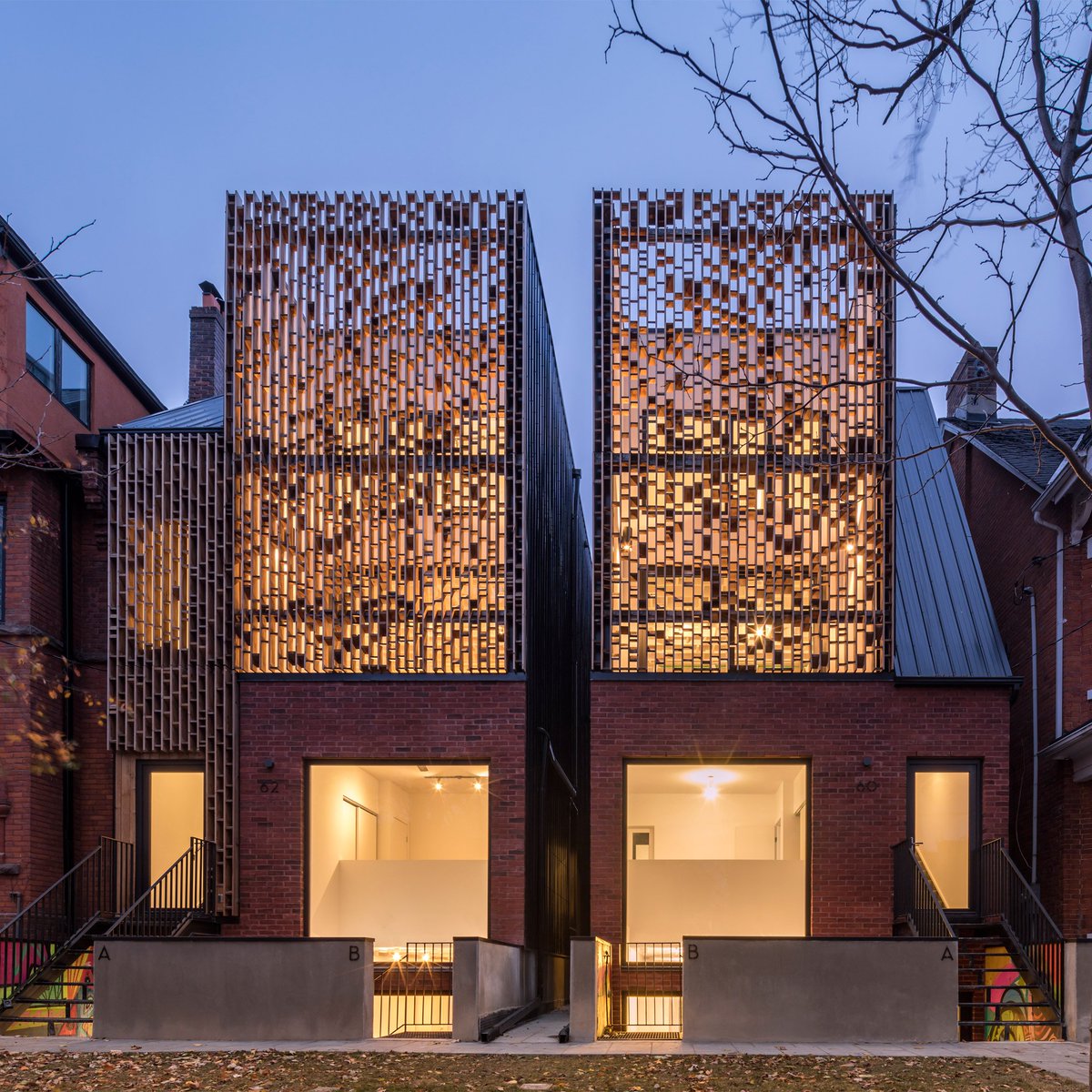 dezeen's tweet photo. Batay-Csorba creates urban townhouses in Toronto faced with brick and wooden screens: https://t.co/8LroKvagOv https://t.co/olnXmWk2b5