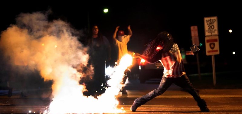 ajplus's tweet photo. Edward Crawford is the 3rd Ferguson activist found dead inside a car. He was seen protecting children from tear gas in this iconic photo. https://t.co/vKaI3FHPuG