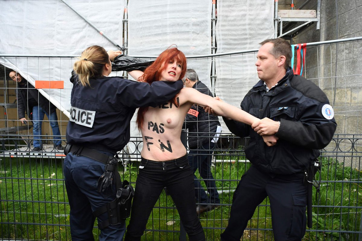 Femen protest banner unfurled at the polling station Le Pen C_NpK0jXoAA2o1f