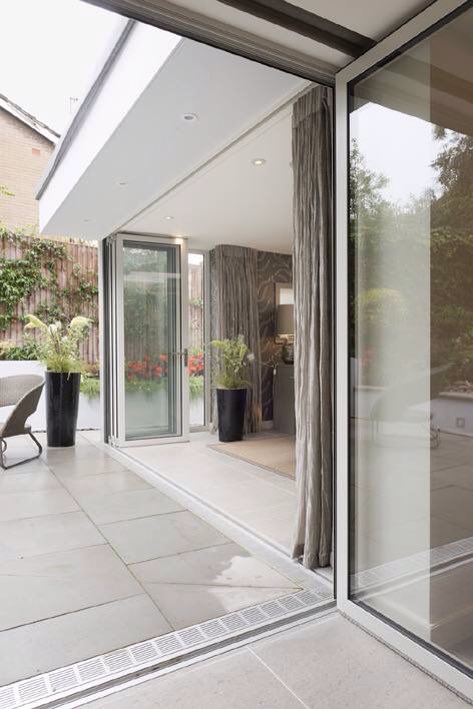 The raised garden was excavated to create a patio. Three sets of external doors provide external access by Seary Architects. #design