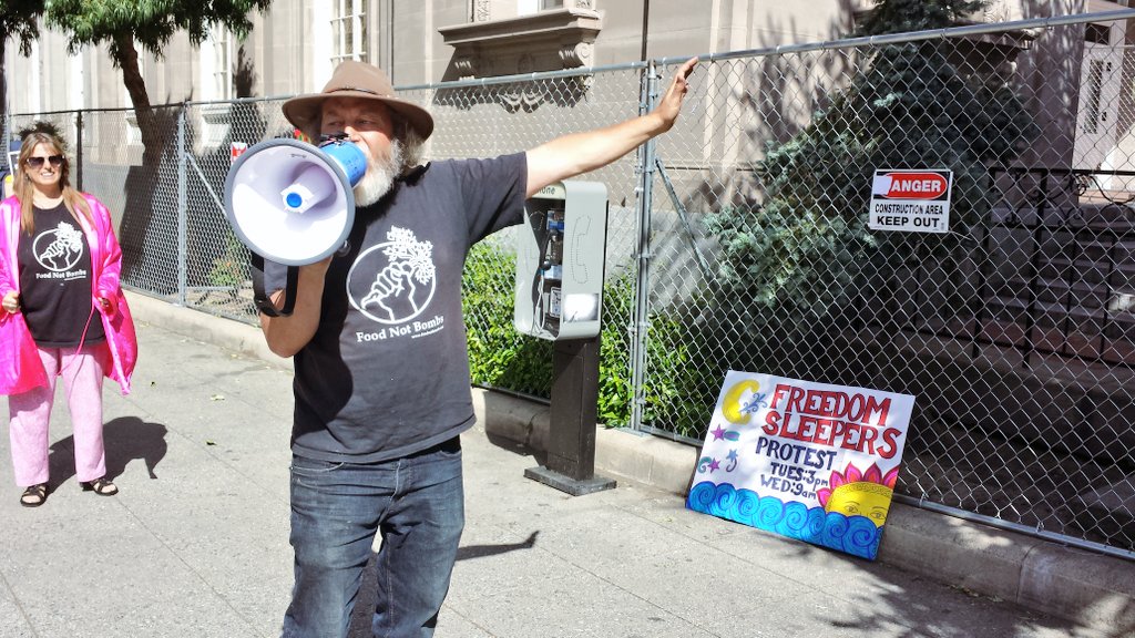 scimc's tweet photo. Keith McHenry in front of anti-homeless fence at Santa Cruz Post Office. #FreedomSleepers #FoodNotBombs https://t.co/PHamM04dj9