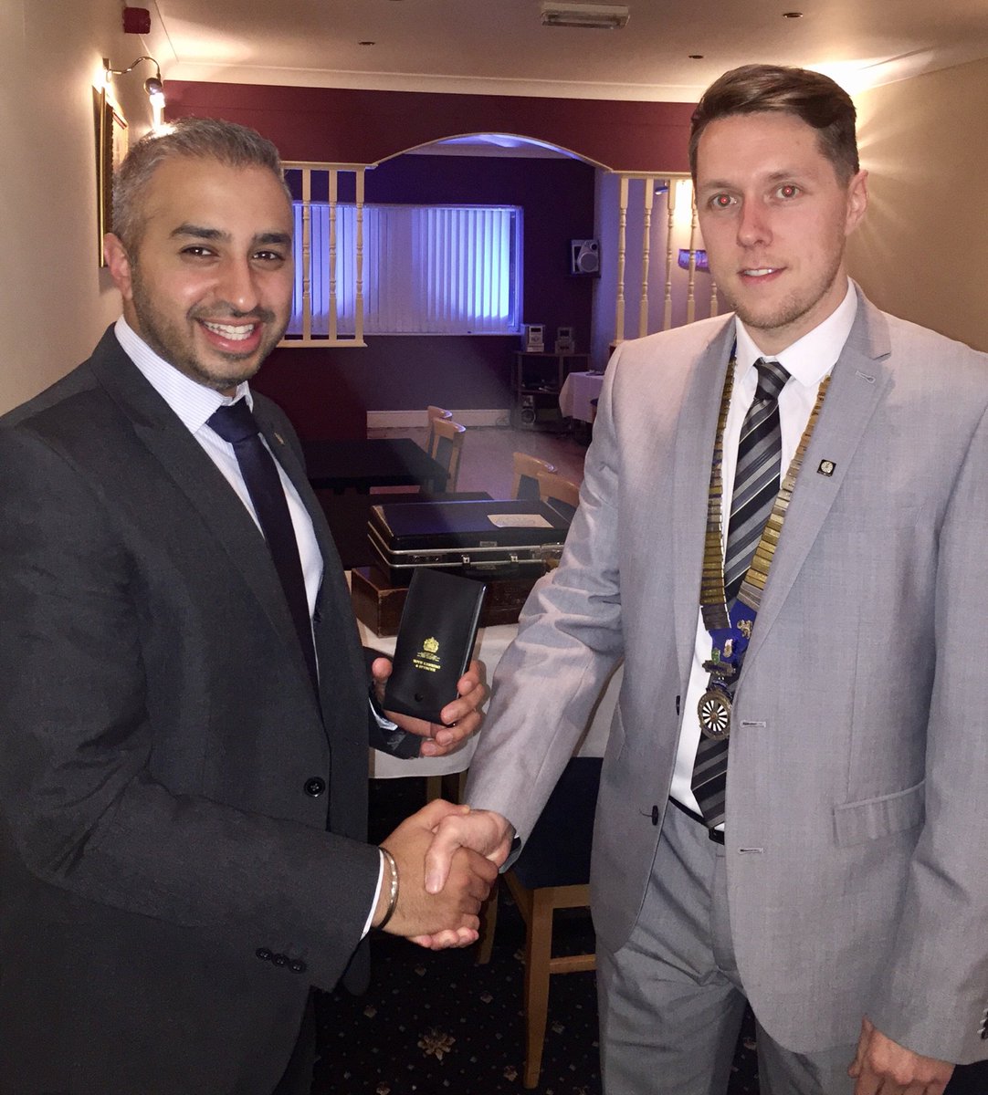 Scunthorpe Round Table Chairman Liam Fox handing Aman Othi his Past Chairman medal