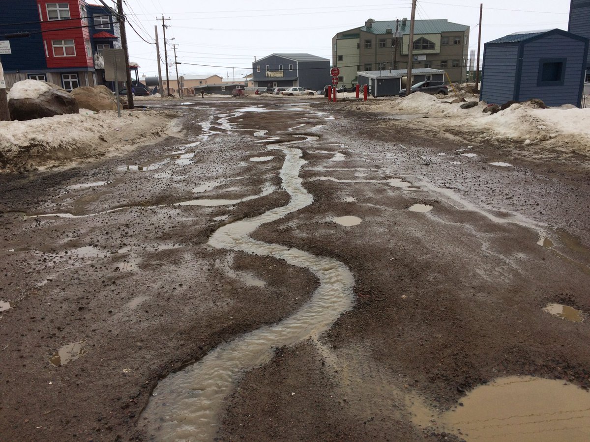 A rivulet snakes it's way down Palaugaa Dr. in Iqaluit as the melt continues.