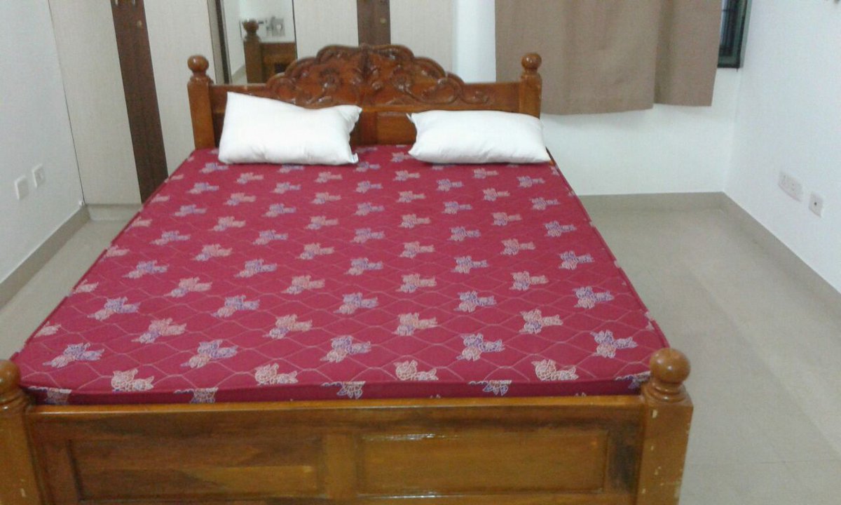 wooden cot with mattress