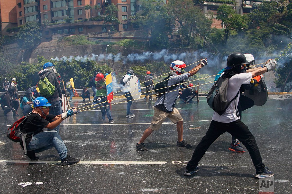 AP_Images's tweet photo. Innovative protesters in #Venezuela are using makeshift weaponry &amp; protective gear. https://t.co/708CSfcDmc @JFernandoLlano @CubillosAriana https://t.co/smjQWlpReY