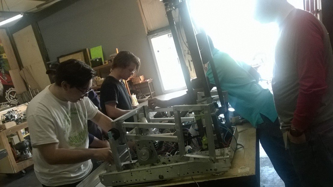 Team_4352's tweet photo. Here's us from Mark's Shop, building the robot and mutilating our old robot, Kyle. He will most likely be reborn. https://t.co/13H5LrRt82