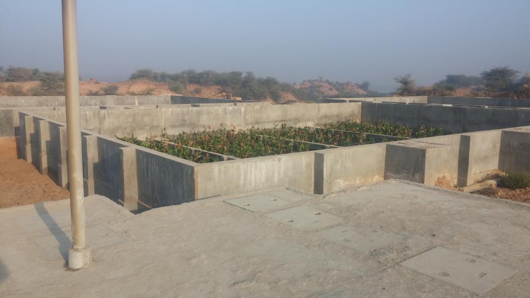 iitgncampus's tweet photo. Sewage treatment plant, anaerobic reactor in the foreground and root-zone treatment area (with plants) in the back. https://t.co/27BYLljWrK