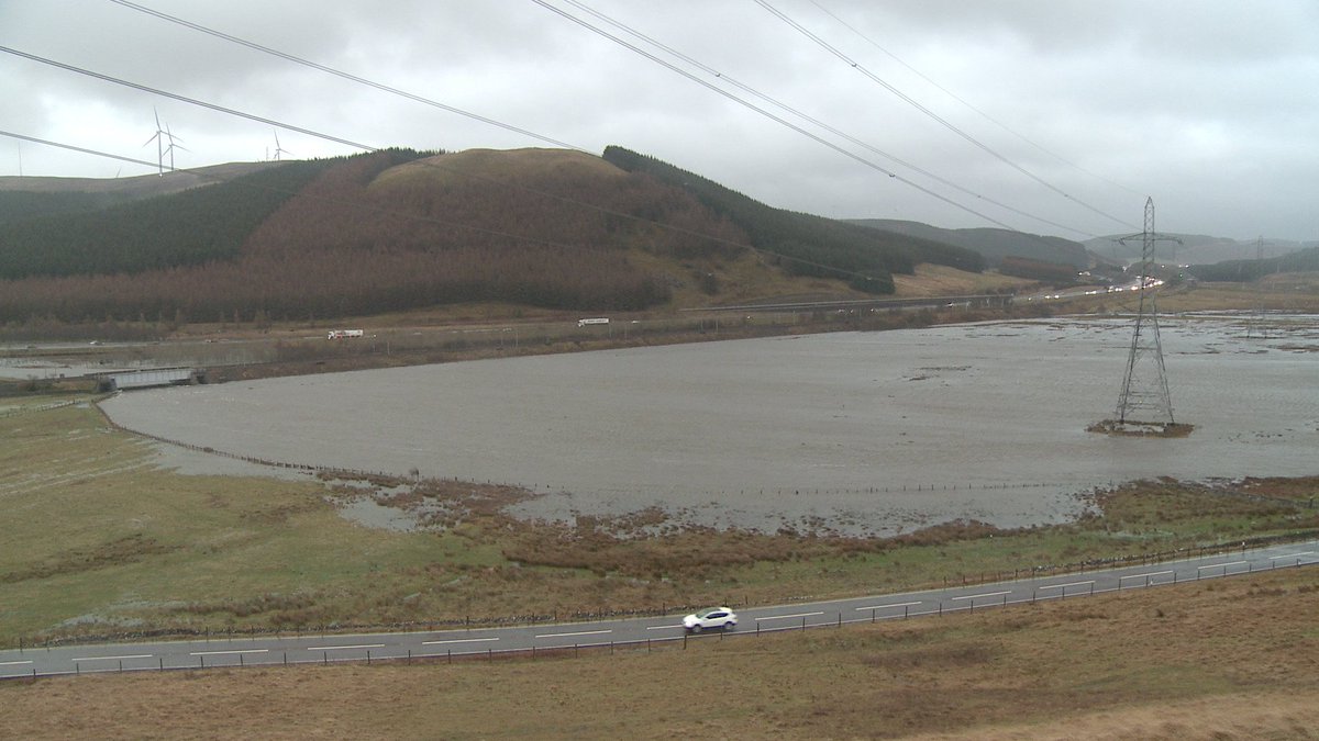 TheSameHillside's tweet photo. As #StormHenry rolls in, a flashback to #StormFrank - video still of top of Clyde flooded out next to M74 https://t.co/1mqeAJ7Xl8