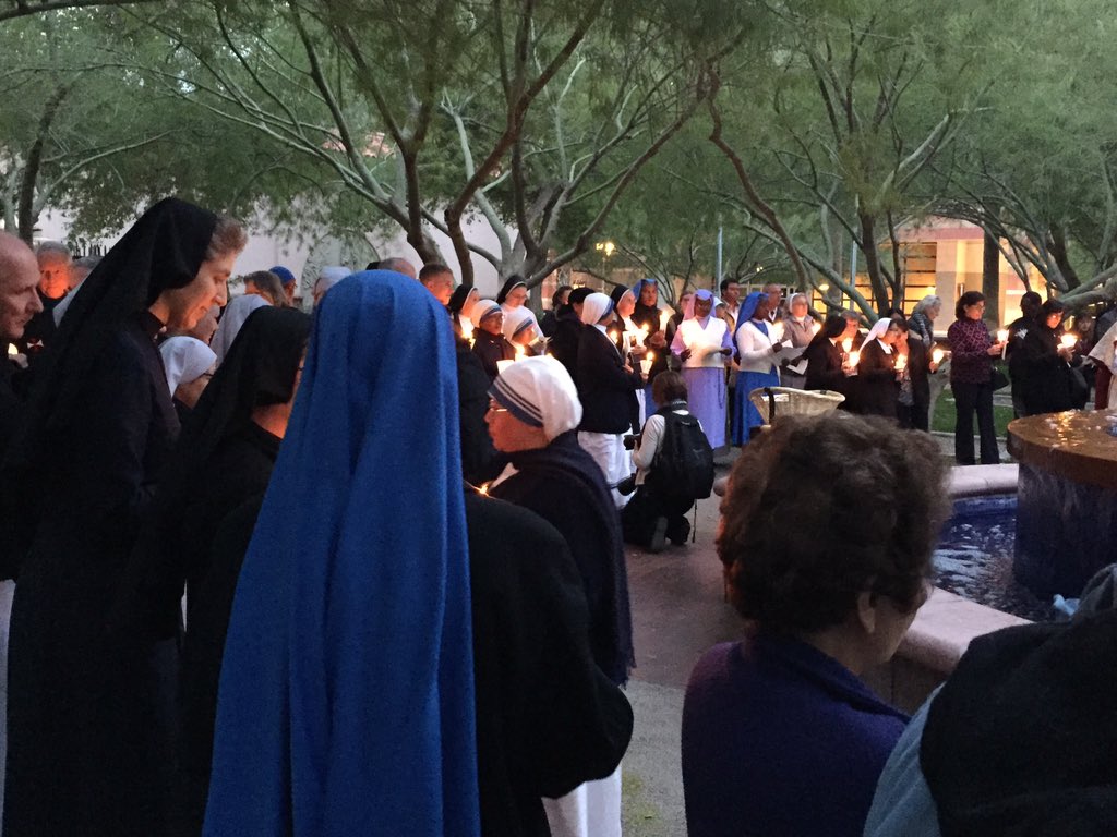 thecatholicsun's tweet photo. Priests &amp; religious joined by @BishopOlmsted lighting candles. https://t.co/6rfEPL0Kts