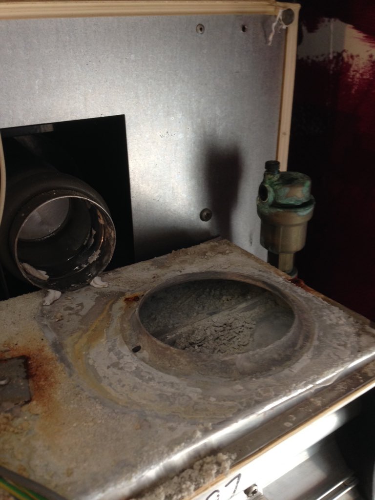 Old boiler, no longer parts, someone took fan of another make and made fit with silicone!! And made flue with waste!