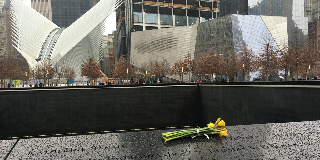 Sept11Memorial's tweet photo. A bouquet of yellow flowers left for Leah Elizabeth Oliver on the #911Memorial endures the rain. #NYC https://t.co/3D22iCgiiC