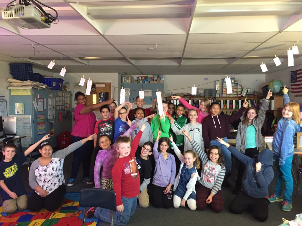 Class 1 pointing to their favorite fraction on the number line they created.We used benchmark fractions to help us!