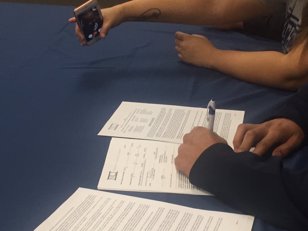 GlendaleUnionAZ's tweet photo. Carson Taylor signing to play football @NAU as dad watches via cell. #ApolloProud #WeAreGUHSD https://t.co/SQikjZX3qd