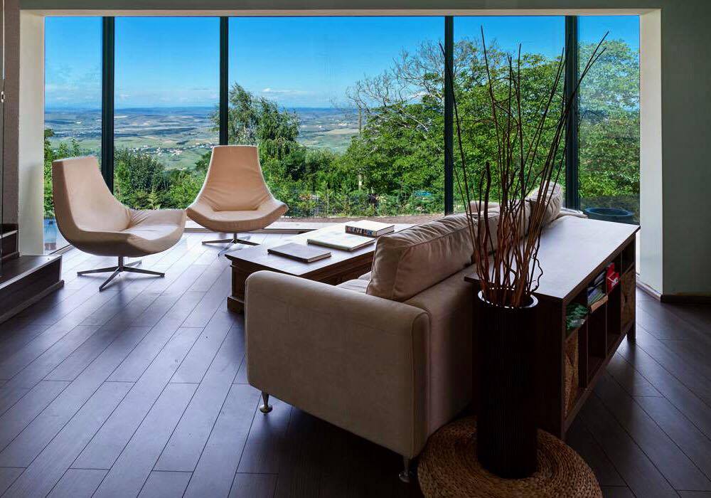 Inducing an outdoor feel, floor-to-ceiling windows create a visual bridge to our home`s surroundings.