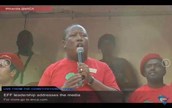 eNCA's tweet photo. NOW LIVE: Julius #Malema addressing EFF members outside the #Concourt https://t.co/AUufI9ExC0 https://t.co/FrOFMxUJOH
