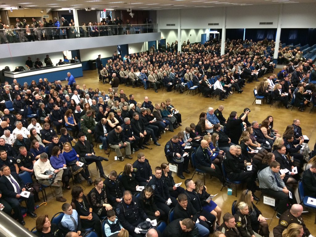 Maggie_Vespa's tweet image. Just seated in Seaside Convention Center. Huge crowd. Officers passing out programs &amp;amp; wristbands for Sgt. #Goodding