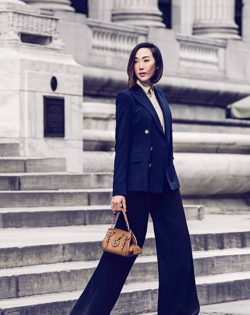 RalphLauren's tweet photo. Chriselle Lim in an RL navy suit & mini #RickyBag at historic NY Public Library #NYFW #RLIcons RT @CHRISELLEtweets https://t.co/RxQ9Q0f7BA