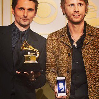 muse's tweet image. Won a f*#%ing Grammy! Missing our 3rd amigo (he's here in spirit on Dom's iPhone) #MuseDrones #bestrockalbum