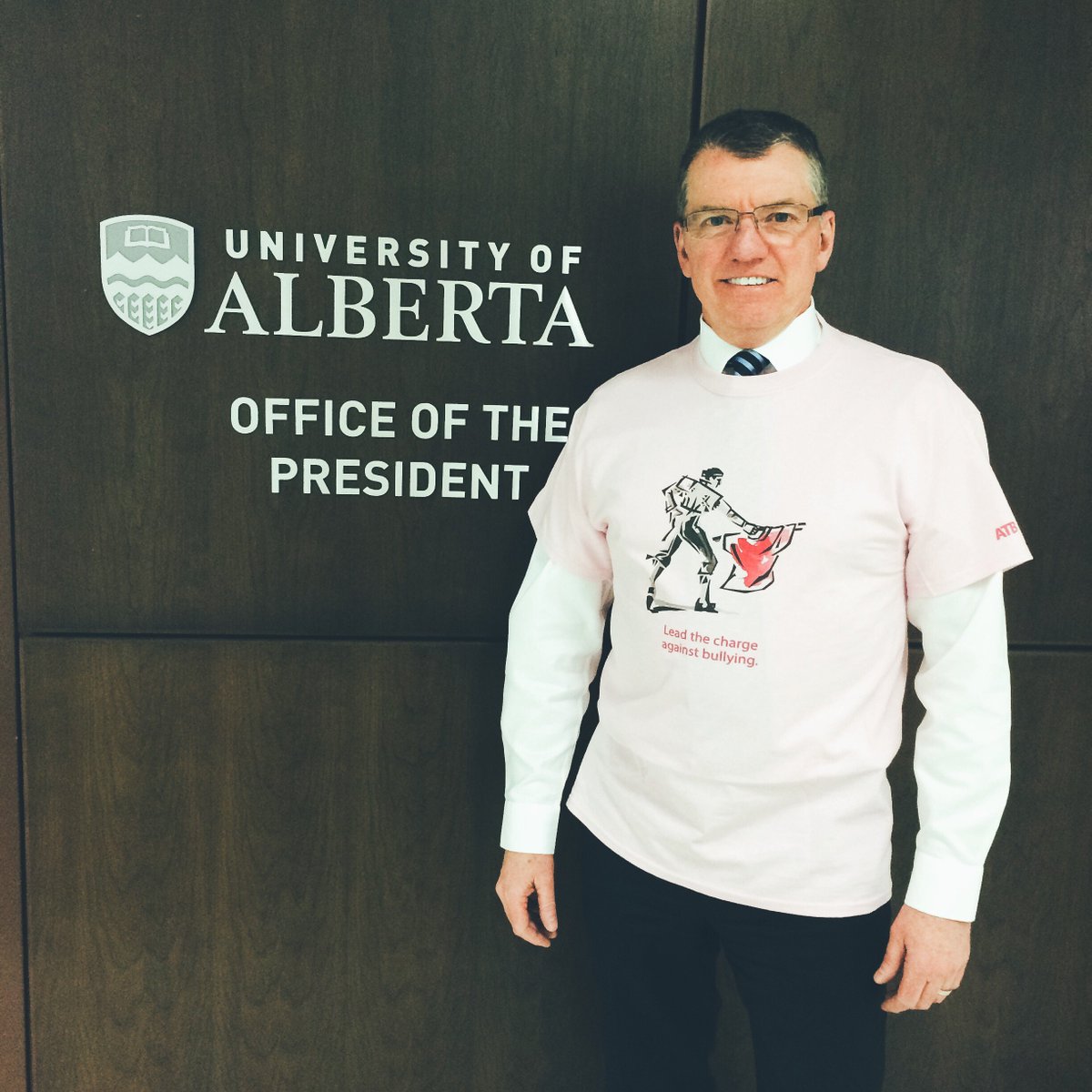 UAlberta's tweet photo. President Turpin proudly showing his support for #PinkShirtDay! #AlbertaPink https://t.co/8cyzXP0csJ