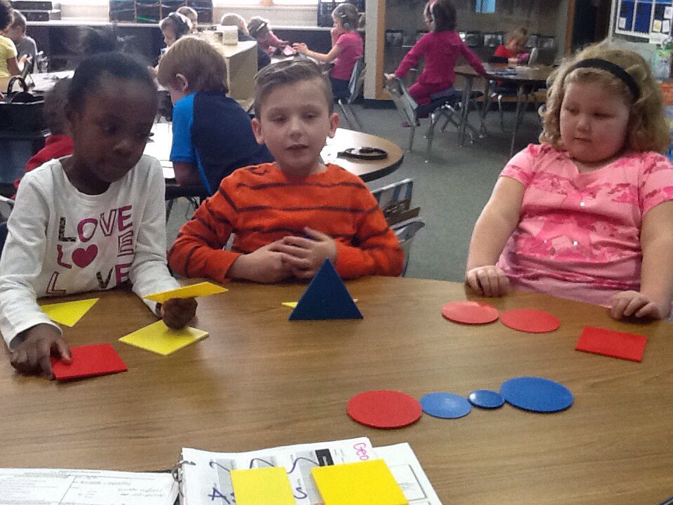 HESKaufman's tweet image. Reviewing attributes of shapes with the train game #mathgroup #sharingthinking