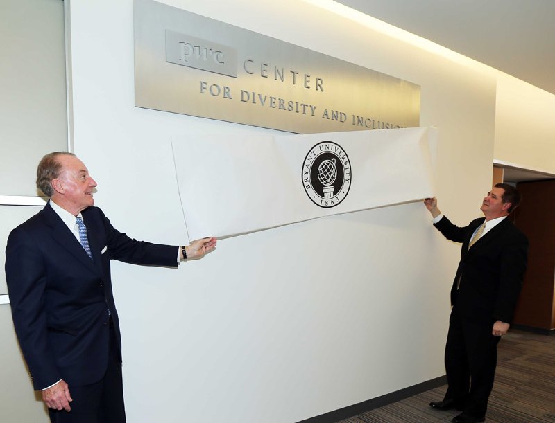 Bob Calabro '88, r., of @PwC_LLC, <a href="/BryantUPrez/">Ronald Machtley</a> unveil @BryantCDI sign honoring PWC gift supporting diversity effort
