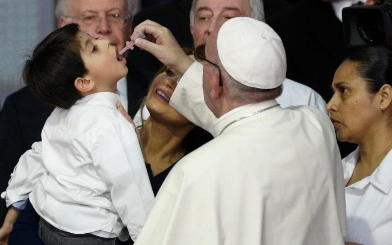 Pope Francis gives a child a POLIO VACCINE! (CNS)