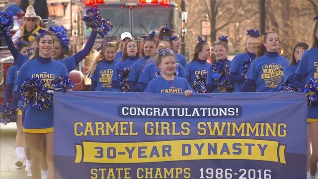 Carmel girls swim team honored with parade and celebration for breaking a national record.  bit.ly/1SYDghw