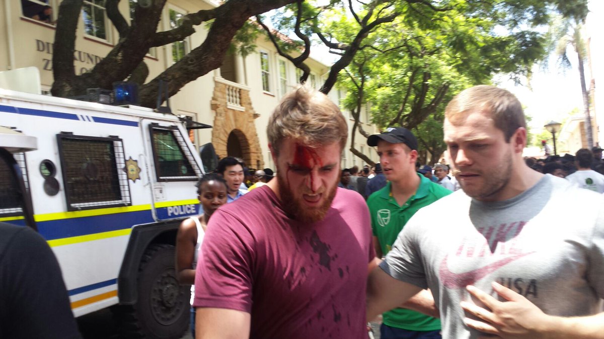 Pro-Afrikaans protester injured with a mop.  Mop was whipped at him. #TuksLanguagePolicy