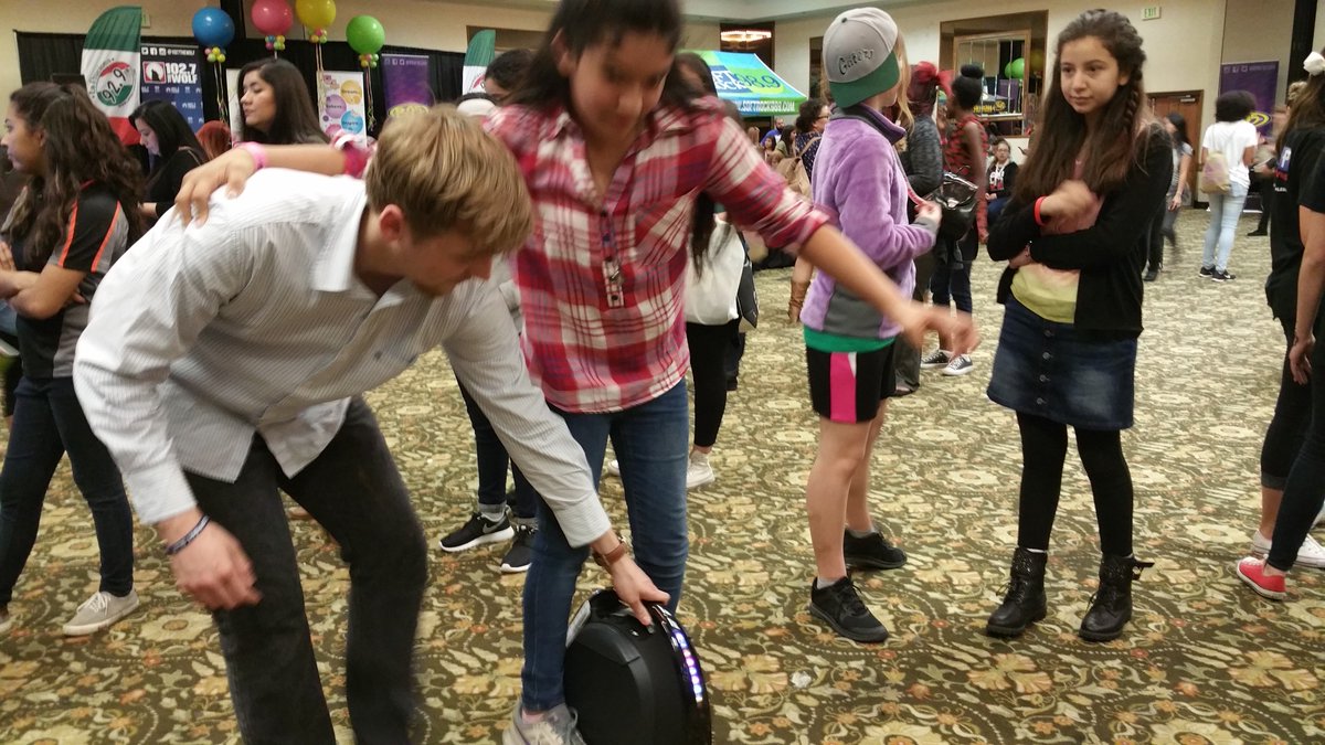 GetGotWay's tweet image. Sean is helping a girl at the #GirlsWorld expo ride a GotWay. She loves the product! #GetGotWay