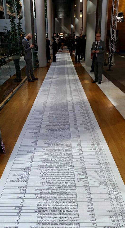 VALERIEinNYT's tweet photo. The names names of 17306 migrants drowned in the Mediterranean is 100m long. Placed on floor of European Parliament https://t.co/R07s46PMSH