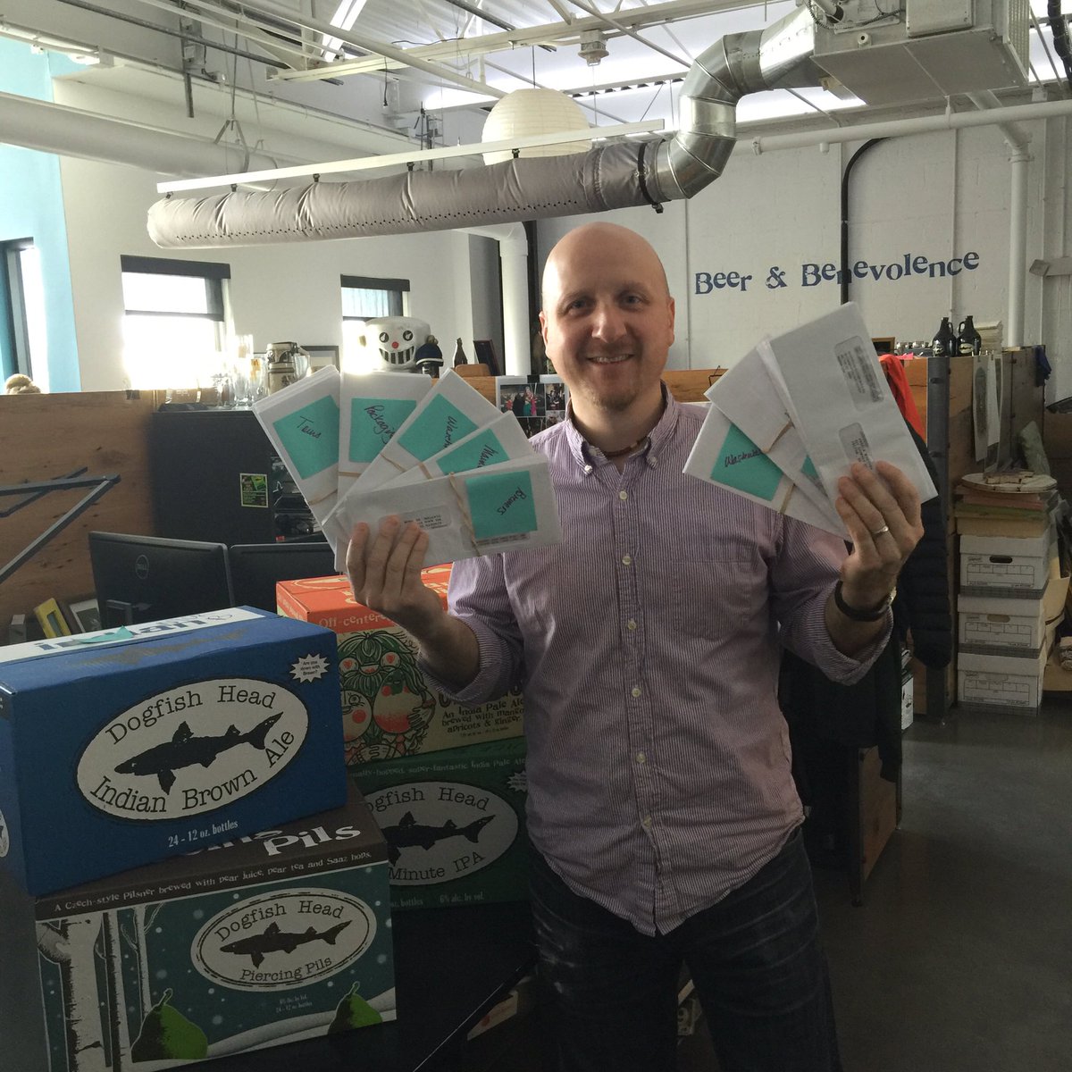 dogfishbeer's tweet photo. Better than a payday case week? It's bonus week! Nick is making the rounds today with checks &amp; hugs for co-workers! https://t.co/NsauKw1sbh