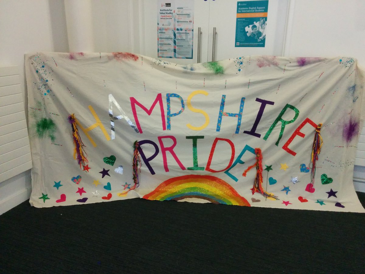 SustAtSUSU's tweet photo. Banner from Hookers, Knitters &amp; Stitchers at @winchesterart and a very proud dog! @HampshirePride https://t.co/xlAtgb5N4V