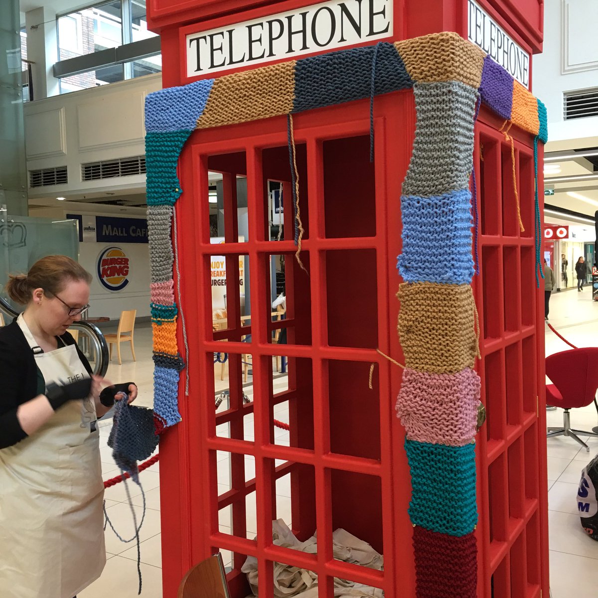 teaandcrafting's tweet photo. We're having a blast at The Kings Mall, Hammersmith yarnbombing a phone booth #theknitfactory #knitting @yarnbombing https://t.co/QBlv7FiTvs