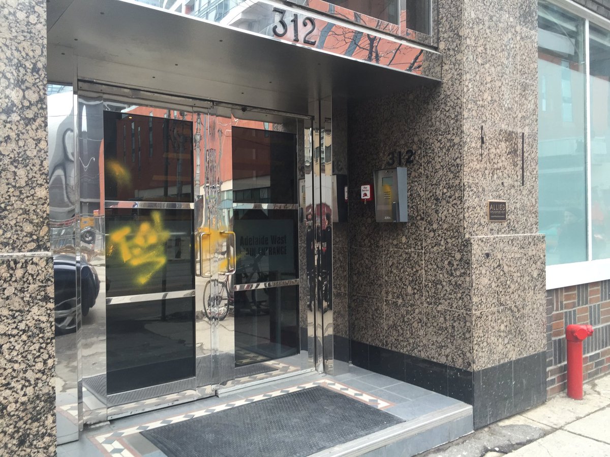 erindesign's tweet photo. Uber office vandalized with taxi cab yellow spray and their sign tore off the building. #uber #ctv #ctvcatch https://t.co/w5KDIREnmn