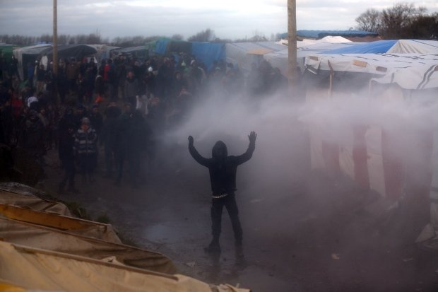 OccupyToronto's tweet photo. Grenades and water cannons used against refugees in Calais - https://t.co/Gj9vzDFx0Y #ows #france @OccupyParis https://t.co/EGw8cjgkuI