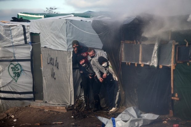 OccupyToronto's tweet photo. Grenades and water cannons used against refugees in Calais - https://t.co/Gj9vzDFx0Y #ows #france @OccupyParis https://t.co/EGw8cjgkuI