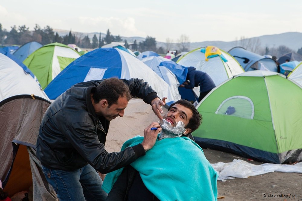 MSF_Sea's tweet photo. The "Barber of #Aleppo" is bringing dignity back to men trapped in the chaos/mess of #Idomeni with a quality shave. https://t.co/Yj4FEwbomG