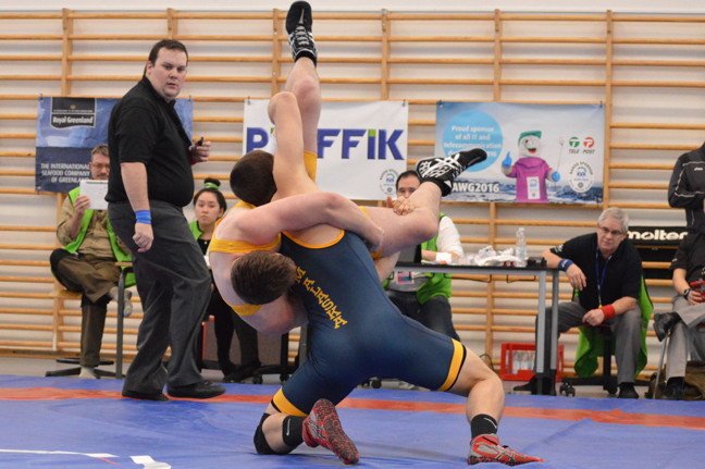 NunatsiaqNews's tweet photo. Iqaluit's Andrew Tucker in yellow: Team NU on the podium with broze ulu in Team Wrestling March 8 #2016AWG https://t.co/ixyKx8kKTE