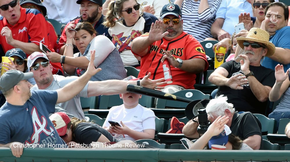 nytimes's tweet image. A father stops a bat that was about to hit his son. A photographer captures the moment. nyti.ms/1Udkkuc