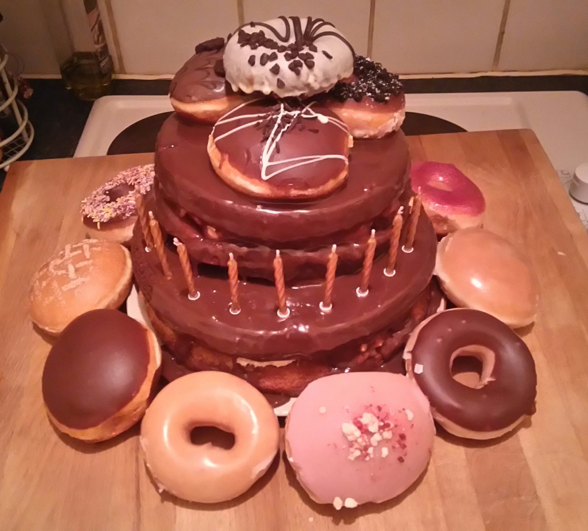MorwennaSolange's tweet photo. Baked a Krispy Kreme cake for my sister last night. Pretty pleased with myself. #AssortedDozen @krispykremeUK https://t.co/3lhnKMpw3B